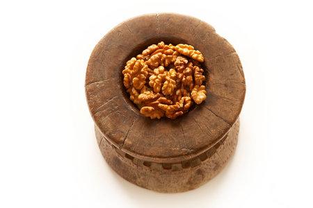 Walnuts in antique, wooden mortar.の写真素材