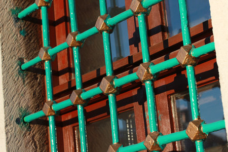 The old stone building. Metal window railing.の写真素材