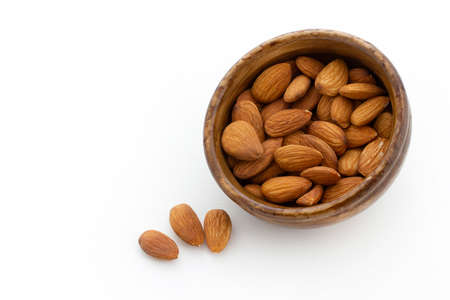 bamboo bowl of almonds on white backgroundの写真素材
