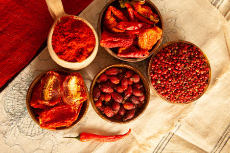 Red colored food. Dried healthy food spices. Dried tomatoes, dried peppers, rosehips, red pepper seeds, red pepper.の写真素材