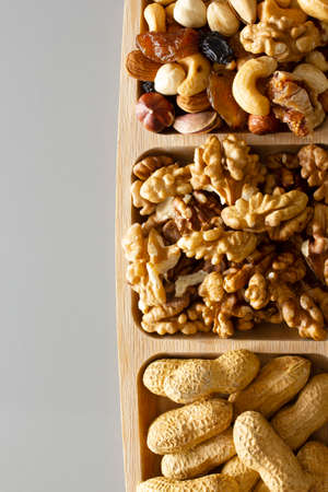 Mixed nuts in a bamboo plate. Healthy food concept.の写真素材