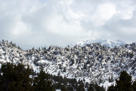 Snow covered mountains on a cloudy dayの写真素材
