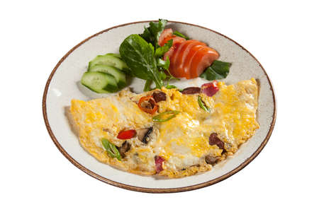 Omelet with vegetables, mushrooms and sausage in a plate