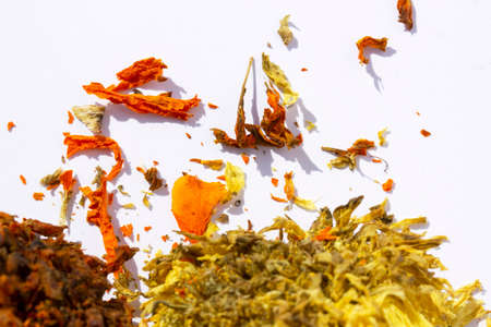 yellow and orange color dry flower petals on a white background