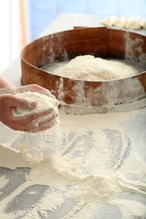 chef sifting flour for bread makingの写真素材