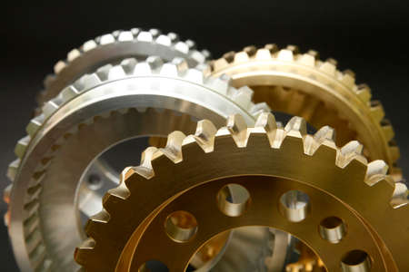 Steel and copper gears on a black background.の写真素材