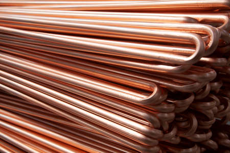 Copper pipes in factory, industrial background