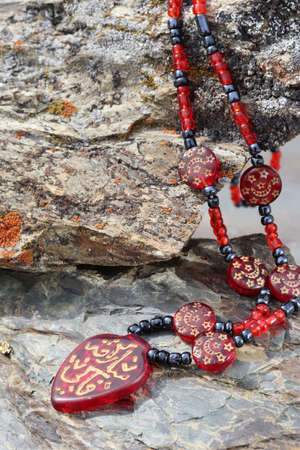 red agate necklace on stoneの写真素材