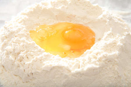 egg yolk on white flour for doughの写真素材