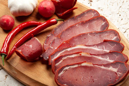 Dried pastrami slices on wooden boardの写真素材