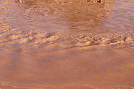 natural background. Brown muddy rain water