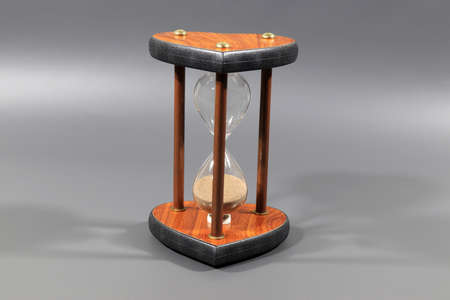 wooden hourglass on colored background
