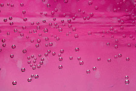 close-up water drops, pink backgroundの写真素材