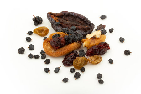Various dried fruits on a white background. Walnuts, blueberries, currants, raisins, prunes, dried apricotsの写真素材