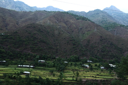 Beautiful Scene of houses under the big mountainの写真素材