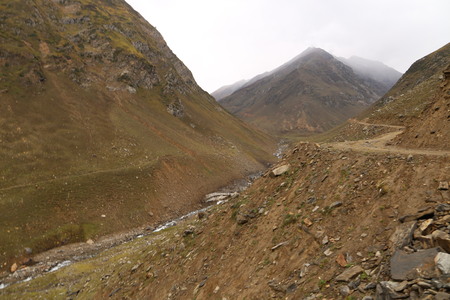 The mountain river flows between the rocks in the mountainsの写真素材