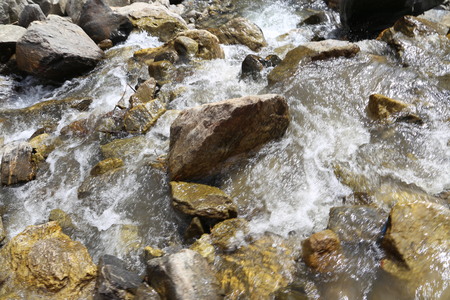 Water flowing over rocks in a streamの写真素材
