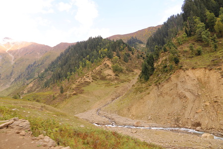 Lake and track passing through between the mountainの写真素材