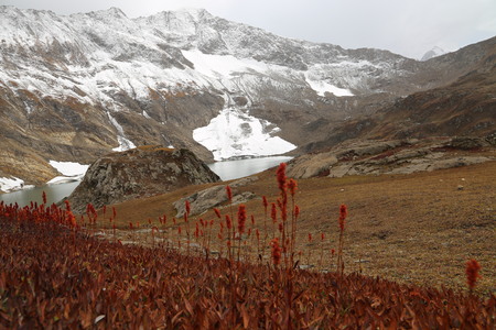 Glacier on mountain with amazing view of lake against the cloudy skyの写真素材