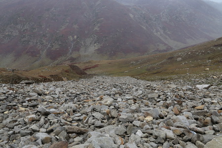 View of the high mountains with rocks on the foregroundの写真素材