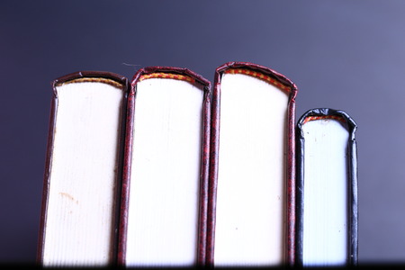Stack of old books isolated on black background