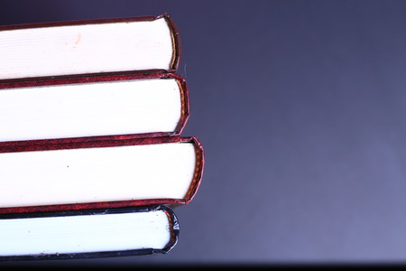 Stack of old books isolated on black background