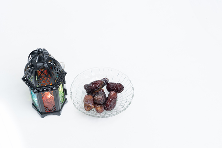Islamic decorative or ornaments, lantern and dates, kurma isolated on white background, iftar preparation, fasting in Ramadan concept. Selective focus.の写真素材