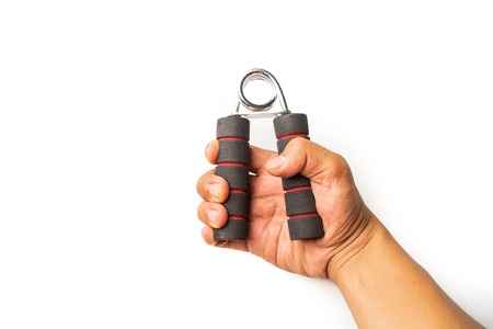 Hand squeezing and gripping hand-grip, strength force, fitness, healthy lifestyle concept on white background, close up selective focus.の写真素材