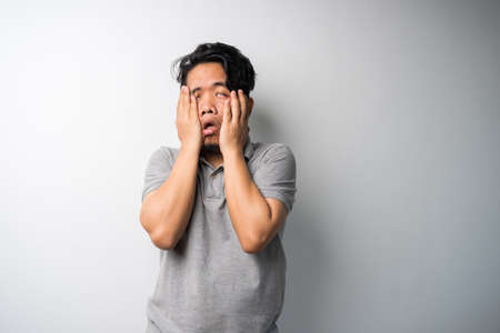 Young Asian man face expression with dslr or mirrorless camera. Photography, creative industry....