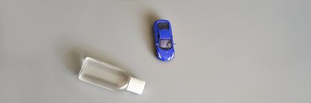 toy car and bottle of sanitizer gel banner