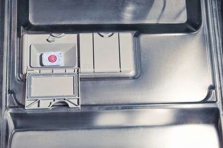 detergent capsule on the background of the dishwasherの写真素材