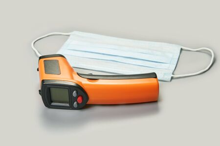 ir scanner thermometer and blue surgical medical maskの写真素材