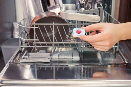 Hand holds detergent of the dishwasherの写真素材
