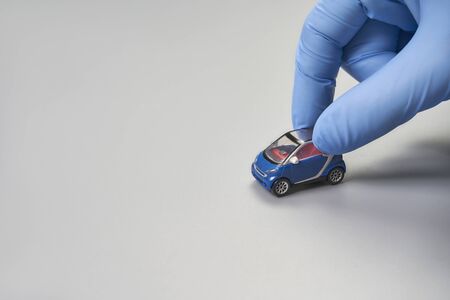 Hand in glove defend toy car.の写真素材