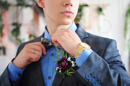 Gentleman at the wedding. Stylish man. Stylish wedding. Costume. Butterfly. Accessories. Men's details. White interior. Wedding decorations. Male life style.の写真素材