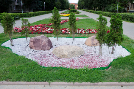 Flowerbed in the form of a circle with stones and flowersの写真素材