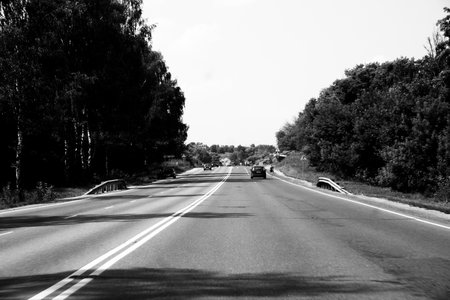 Black and white photo of the road in black and white background.の写真素材