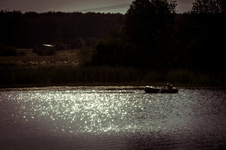 Fishing boat on the river in the evening. Toned.の写真素材