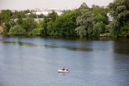 A man rowing a boat on the Moscow river in Countryside, Russia