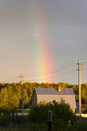 Rainbow over the village in the evening. Russia, Kareliaの写真素材