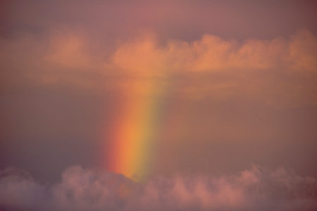Rainbow in the sky at sunset. Beautiful natural background. Toned.の写真素材