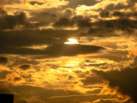 Sunset sky with clouds and sunbeams. Beautiful nature background.の写真素材