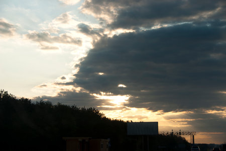 Sunset over the forest with clouds in the blue sky. Nature backgroundの写真素材