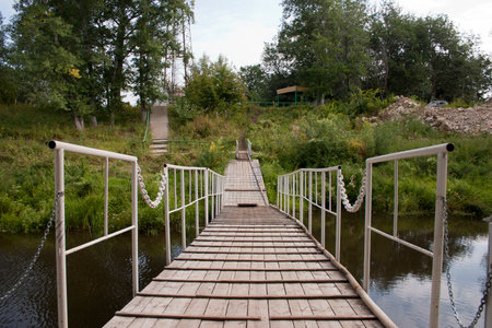 wooden bridge over the river in the village of Samaraの写真素材