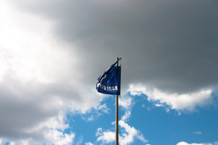 Waving flag of the Russian Federation against the blue sky with cloudsの写真素材