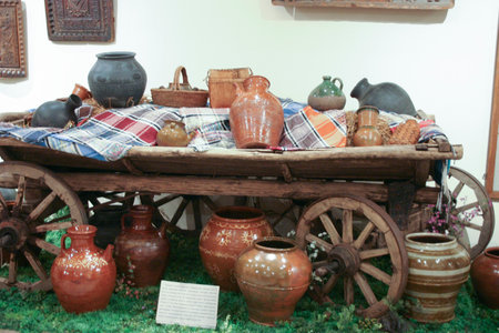 Antique clay pots on a wooden cart in a rustic styleの写真素材