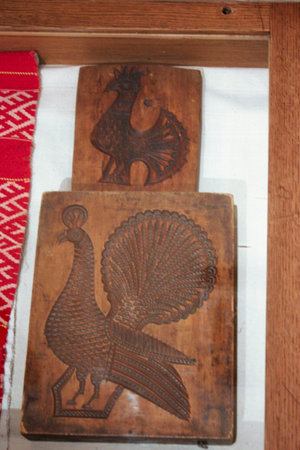 Wooden carved chicken and turkey on a wooden tray in a restaurantの写真素材