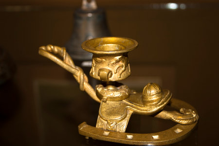 Antique brass candlestick on a dark background close-upの写真素材