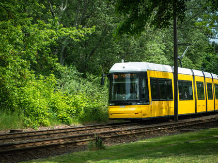 Berlin, Germany, May 17, 2022. Yellow tram on the railway tracks. Berlin, Germany.
