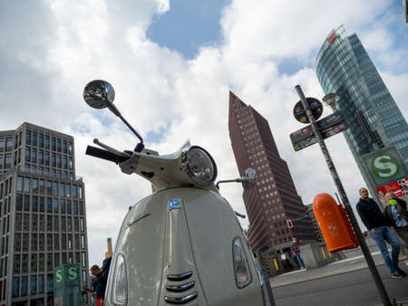 BERLIN, GERMANY - May 21, 2022; Scooter on the background of skyscrapers. vintage moped. Podzdam Square. May 21, 2022 Berlin Germanyのeditorial素材